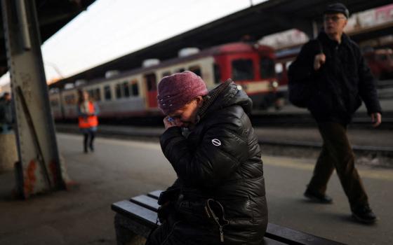 A Ukrainian refugee at North Railway Station in Bucharest, Romania, cries as she says goodbye to a family member March 14, 2022, following the Russian invasion of Ukraine. (CNS photo/Edgard Garrido, Reuters)