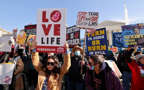 Demonstrators are seen outside the Supreme Court Dec. 1, 2021, ahead of oral arguments in Dobbs v. Jackson Women's Health, a case involving Mississippi's law banning most abortions after 15 weeks. (CNS/Reuters/Evelyn Hockstein)