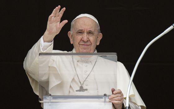 Pope Francis greets the crowd as he leads the Angelus from the window of his studio overlooking St. Peter's Square March 27 at the Vatican. (CNS/Vatican Media)