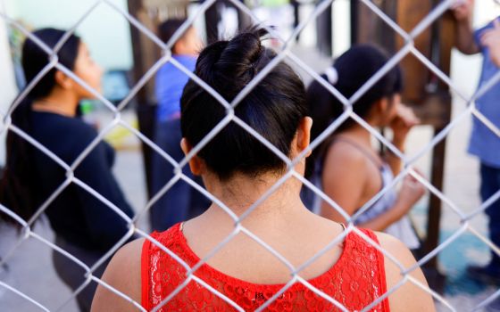 Migrants from Central America, who were returned to Mexico under Title 42 after seeking asylum in the U.S., stand inside the El Buen Samaritano shelter in Ciudad Juarez, Mexico, April 21, 2022. (CNS photo/Jose Luis Gonzalez, Reuters)