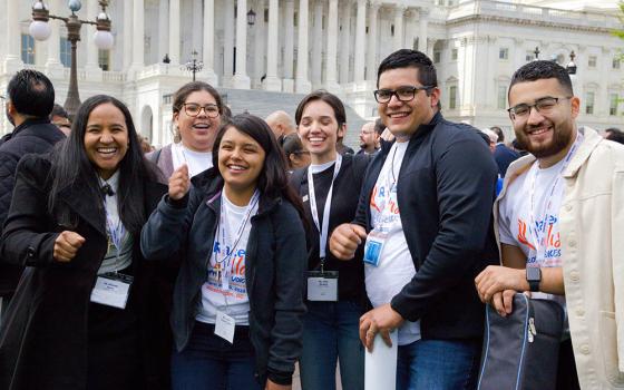 Kimberly Garcia, Guadalupe Saez, Janet Chávez España, Karla Miranda, Alejandro González and Marvin Molina from the Diocese of Arlington, Virginia, pose for a photo near the U.S. Capitol in Washington April 27 during the Raíces y Alas advocacy day.