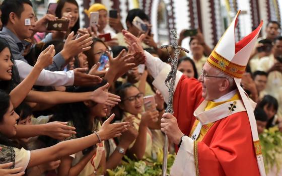 Pope Francis greets young people after celebrating Mass Nov. 30, 2017, at St. Mary's Cathedral in Yangon, Myanmar.