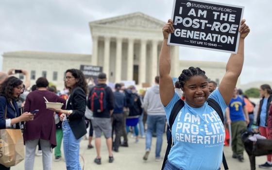 Norvilia Etienne, of Students for Life, holds a sign outside the Supreme Court of the United States May 3, the day after a draft of the court's opinion was leaked signaling that the court was leaning toward overturning Roe v. Wade. (CNS/Rhina Guidos)