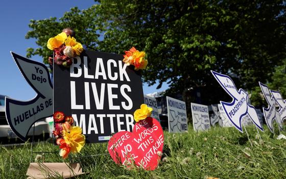 A memorial near a TOPS supermarket in Buffalo, New York, is seen May 15. Authorities say the mass shooting the day before that left 10 people dead was racially motivated. (CNS/Reuters/Brendan McDermid)