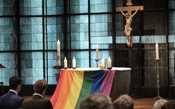 The altar is draped with a rainbow flag during the blessing service "Love Wins" in the Church of St. Martin in Geldern, Germany, May 6, 2021. (CNS photo/Rudolf Wichert, KNA)