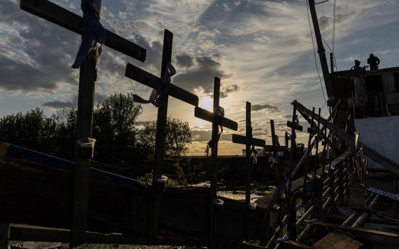 Crosses are attached to the destroyed bridge in Irpin, Ukraine, May 16, during Russia's invasion of Ukraine. (CNS/Reuters/Jorge Silva)