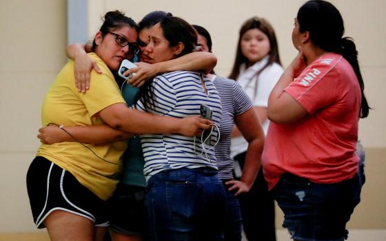 People react outside the SSGT Willie de Leon Civic Center, where students had been transported from Robb Elementary School after a shooting, in Uvalde, Texas, May 24, 2022. (CNS photo/Marco Bello, Reuters)