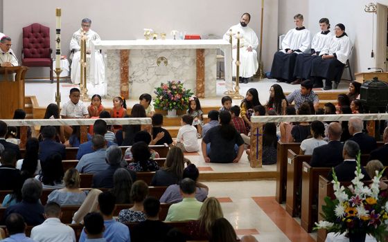 Children at Sacred Heart Catholic Church in Uvalde, Texas, attend Mass with President Joe Biden and first lady Jill Biden May 29. A gunman killed 19 children and two teachers at Robb Elementary School May 24. (CNS/Reuters/Jonathan Ernst)