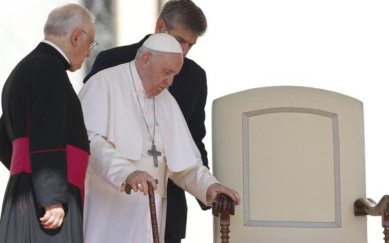 Pope Francis arrives at his chair during his general audience in St. Peter's Square June 8 at the Vatican. (CNS/Paul Haring)