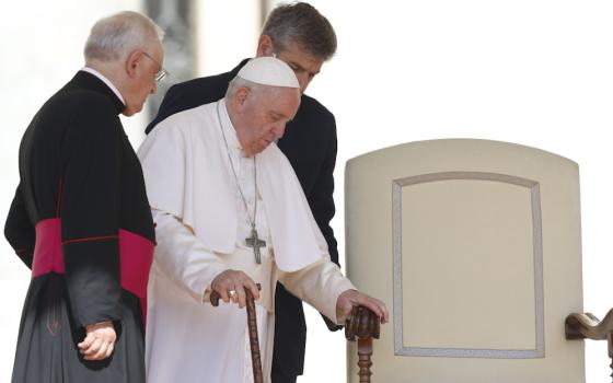 Pope Francis arrives at his chair during his general audience in St. Peter's Square at the Vatican June 8. (CNS/Paul Haring)