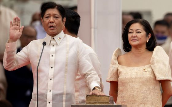 Ferdinand "Bongbong" Marcos Jr., the son and namesake of the late dictator Ferdinand Marcos, takes the oath of office beside his wife, Louise Araneta-Marcos, during the presidential inauguration ceremony at the National Museum in Manila, Philippines.