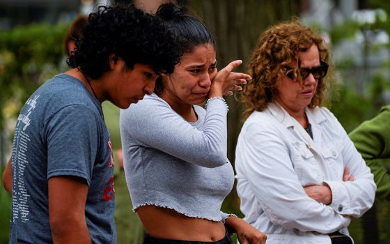 Jazel Ramos, niece of victim Eduardo Uvalde, cries while visiting a memorial site July 6 in Highland Park, Illinois, after a mass shooting at a Fourth of July parade. (CNS/Reuters/Cheney Orr)