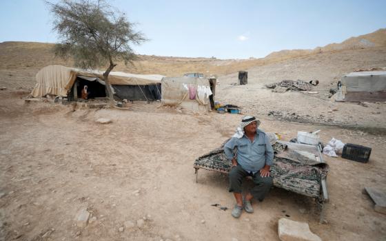 A Palestinian Bedouin sits near his tent near Jericho in the Israeli-occupied West Bank June 27, 2022. (CNS photo/Mohamad Torokman, Reuters)