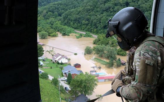 A Kentucky National Guard flight crew from 2/147th Bravo Company flies over a flooded area in response to a declared state of emergency July 29 in eastern Kentucky. (CNS/Sgt. Jesse Elbouab, U.S. Army National Guard via Reuters)