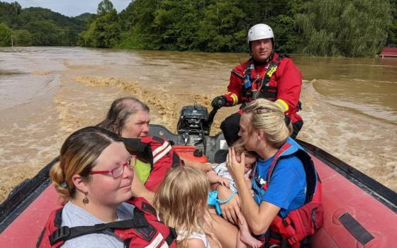 A rescue team member evacuates residents from their homes by boat through flooded Breathitt County streets in Kentucky July 28, 2022. (CNS photo/Wolfe County Search & Rescue Team via Reuters)