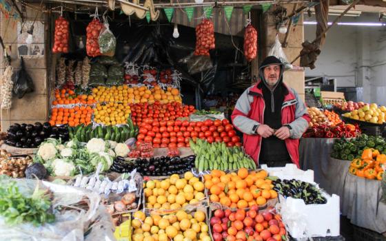 A vendor sells vegetables at a market in Damascus, Syria, March 18, 2022. In a video message released by the Pope's Worldwide Prayer Network Aug. 2, Pope Francis offered his August prayer intention to small- and mid-sized business owners. (CNS photo/Firas