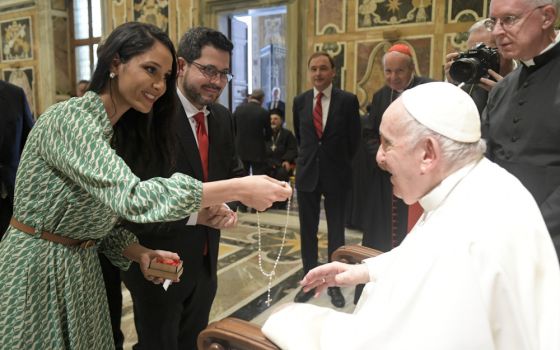 Pope Francis accepts a rosary during an audience with members of the International Catholic Legislators Network at the Vatican Aug. 25, 2022. (CNS photo/Vatican Media)