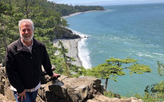 John Mundell poses for a photo against the backdrop of the Puget Sound in the state of Washington. In July, the Vatican Dicastery for Promoting Integral Human Development announced Mundell as director of the Laudato Si' Action Platform. (CNS photo)