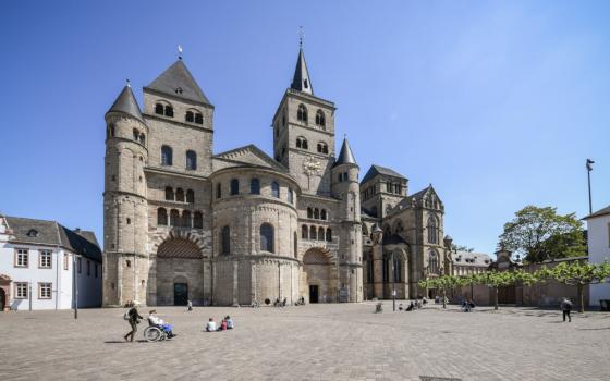 People walk outside the Cathedral of St. Peter and the Church of Our Lady in Trier, Germany, May 15, 2020.