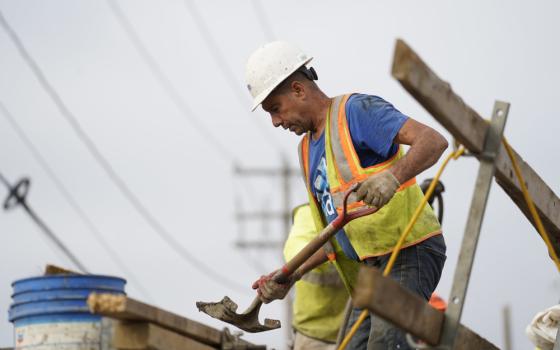 A worker uses a shovel Aug. 30 at a highway construction site in Stony Brook, New York. (CNS/Gregory A. Shemitz)