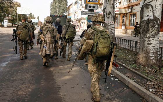 Ukrainian soldiers walk in Bakhmut, in Ukraine's Donetsk region Oct. 1, amid Russia's attack on the East European country. (CNS/Reuters/Zohra Bensemra)