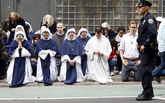 A woman holds a rosary as she joins other pro-life advocates in reciting the rosary during a monthly "Witness for Life" prayer vigil held across the street from a Planned Parenthood center Oct. 6, 2018, in New York City. (CNS/Gregory A. Shemitz)