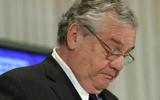 Robert S. Bennett looks down during a press conference about clergy sex abuse.