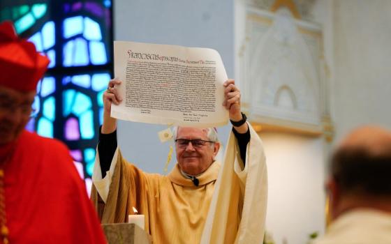 Archbishop George Thomas of Las Vegas processes through the Shrine of the Most Holy Redeemer in Las Vegas with the papal bull from Pope Francis during a Mass.