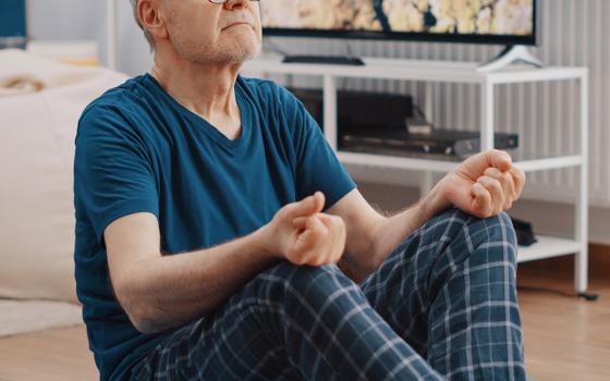 Old man meditating (Dreamstime/Dragoscondrea)