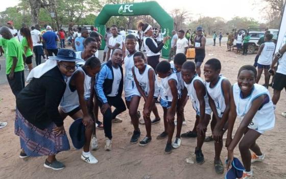 AMR Sr. Grace Moyo, a teacher at the AMR Secondary School in Lupane, Zimbabwe, poses with participants in the Binga Kasambabezi Marathon. AMR sisters organized their students to take part in the Oct. 21, 2023, race, whose theme was "Running for our wildlife conservation" as part of efforts to educate young people about the environment. (Courtesy of AMR)