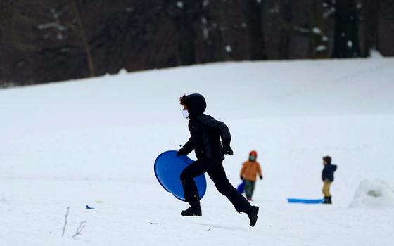 Children in the Brooklyn borough of New York City play in the snow Feb. 10, 2021. (CNS/Reuters/Carlo Allegri)