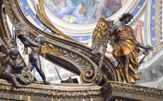 Sculpted angels pictured from below backed by frescoed walls and dome. 