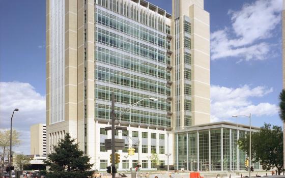 Courthouse looms against bright blue sky