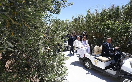 Pope Francis rides in a golf cart with Italian Prime Minister Giorgia Meloni after arriving by helicopter at the Group of Seven summit in Borgo Egnazia, in Italy's southern Puglia region, June 14, 2024. (CNS/Vatican Media)