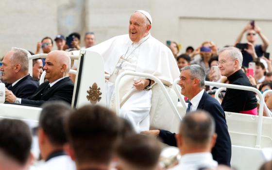 Pope Francis sits in Popemobile