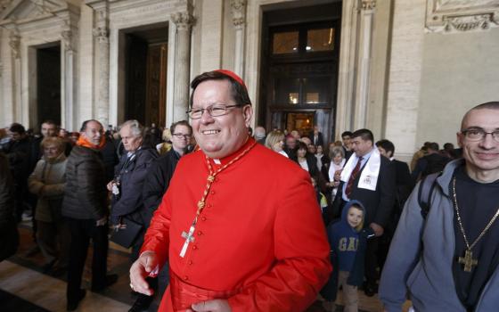 Lacroix, in scarlet, smiles outside St. Peter's. 