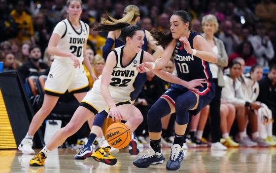 Iowa Hawkeyes guard Caitlin Clark (22) controls the ball against Connecticut Huskies guard Nika Muhl (10) in the Final Four of the women's 2024 NCAA Tournament April 5. Clark, the NCAA basketball all-time scoring record holder, now plays for the WNBA's Indiana Fever. 