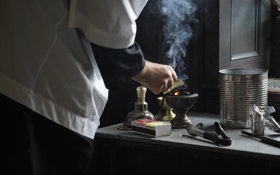 Altar server Bradley Morley prepares a censer for use during a traditional Latin Mass July 1, 2021, at Immaculate Conception Seminary in Huntington, New York. (CNS/Gregory A. Shemitz)