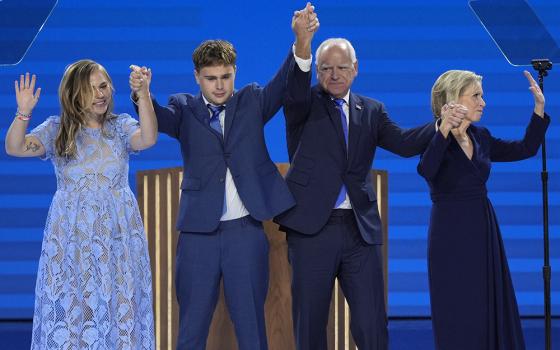 Democratic vice presidential nominee Minnesota Gov. Tim Walz, second from right, poses with his wife Gwen Walz, from right, son Gus Walz and daughter Hope Walz after speaking during the Democratic National Convention, Aug. 21 in Chicago. (AP photo/J. Scott Applewhite)