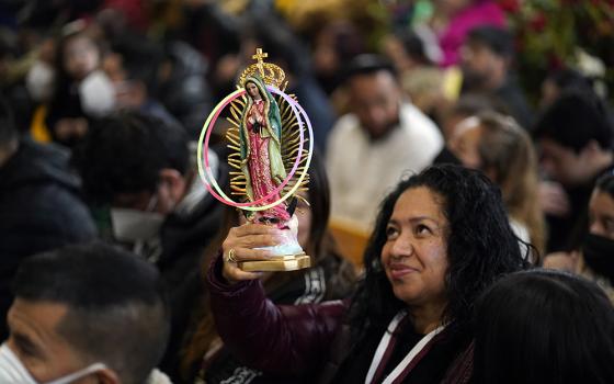 A woman holds a statue of Our Lady of Guadalupe during a Spanish-language Mass celebrated on the eve of the feast of Our Lady of Guadalupe at Our Lady of Mount Carmel Church in Staten Island, New York, Dec. 11, 2022. (OSV News/Gregory A. Shemitz)