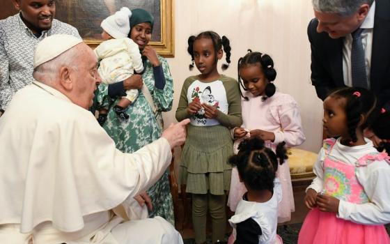 Pope Francis greets a Muslim family from Djibouti at the nunciature in Brussels Sept. 28. As refugees, they had reached Belgium thanks to the help of the Rome-based Community of Sant'Egidio. The visit came during the second full day of the pope's Sept. 27-29 visit to Belgium.  (CNS/Vatican Media)