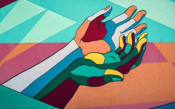 Colorful graphic of two outstretched hands.