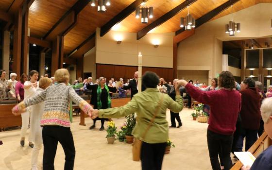 Sisters and guests dance to celebrate Easter at the Benedictine Sisters of Erie monastery in Erie, Pa.