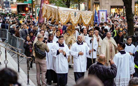 Archbishop Paul Coakley of Oklahoma City, ecclesiastical adviser to the Napa Institute, carries the monstrance during a eucharistic procession through Midtown Manhattan in New York City Oct. 15. A few thousand worshippers packed St. Patrick's Cathedral for Holy Hour and Mass before participating in the procession. (OSV News/Gregory A. Shemitz)