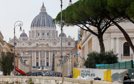 St. Peter's framed by avenue and other buildings, banner foregrounded.