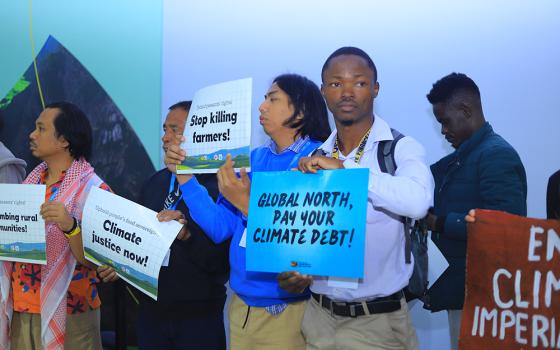 A climate activist takes part in a demonstration Nov. 18 at the COP29 United Nations climate change conference in Baku, Azerbaijan. (EarthBeat photo/Doreen Ajiambo)