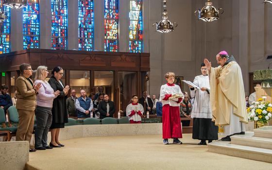 Bishop John Stowe of Lexington, Kentucky, blesses three women acolytes during Mass Nov. 24 at the Cathedral of Christ the King in Lexington. (Courtesy of Maureen C Guarnieri Yeager)