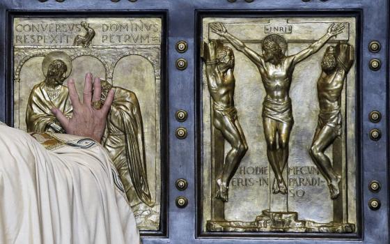 Pope Francis pushes open the Holy Door of St. Peter's Basilica, formally launching the Holy Year of Mercy, at the Vatican, Tuesday, Dec. 8, 2015. (AP Photo/Gregorio Borgia, File)