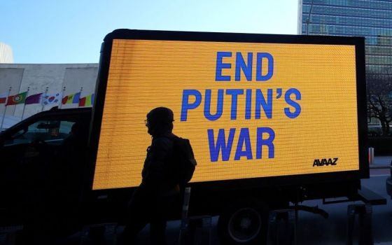 A truck displays an electronic message while protesters demonstrate outside United Nations headquarters in New York City, as diplomats inside hold an emergency session of the 193-member U.N. General Assembly. (CNS/Reuters/Mike Segar)