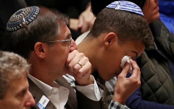 People mourn during a memorial service at the Sailors and Soldiers Memorial Hall of the University of Pittsburgh Oct. 28, 2018, a day after Robert Bowers shot and killed 11 people and injured six others. (CNS/Reuters/USA TODAY sports/Jeffrey Becker)